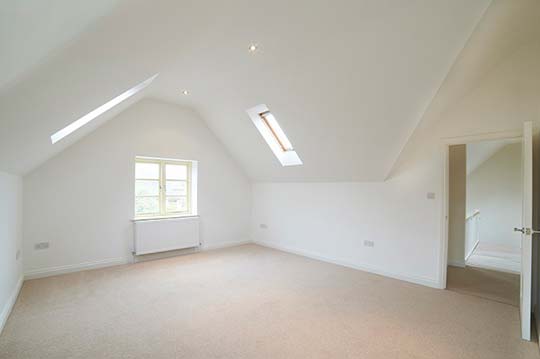 A freshyly decorated room that has been plastered and painted